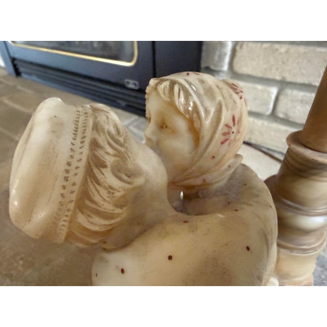 This is a rare italian hand-carved alabaster lamp depicting a young couple engaged in a first kiss (circa late 19th or...