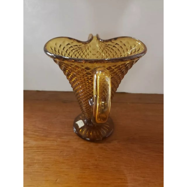 This is a Vintage Amber Glass Pitcher Vase Diamond Point, Made in Italy. It measures 7" high and 8“ wide from spout to...
