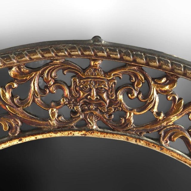 Antique Oscar Bach Bronze Gothic Mirror with Wind God Mask C1910 Measures - 34 3/4" x 19 1/2" x 1 1/4" An antique Oscar...