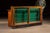 Early retail display counter combining a glass showcase upper with a full-width service counter base, executed in stained...