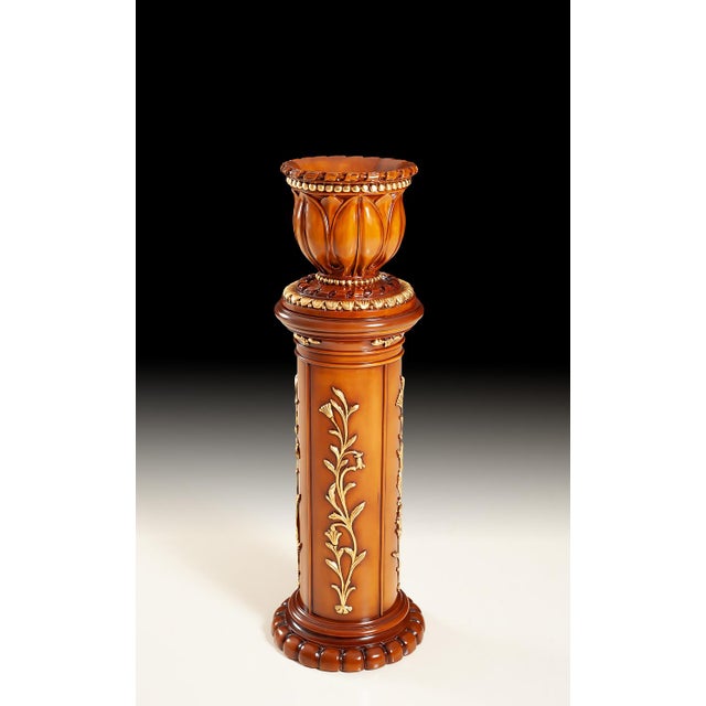 This decorative round column with matching planter is crafted from solid wood and finished in a warm polished tone. The...