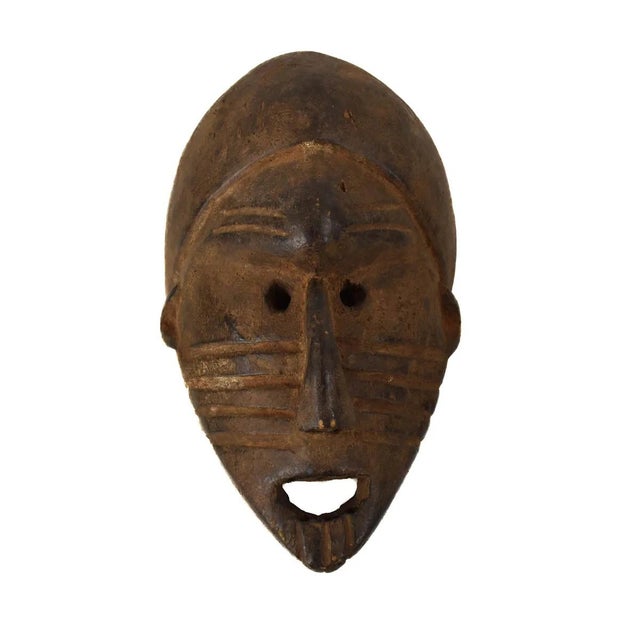 Sukuma masks, characterized by a fearful expression, exaggerated features like applied eyebrows, and often adorned with a...