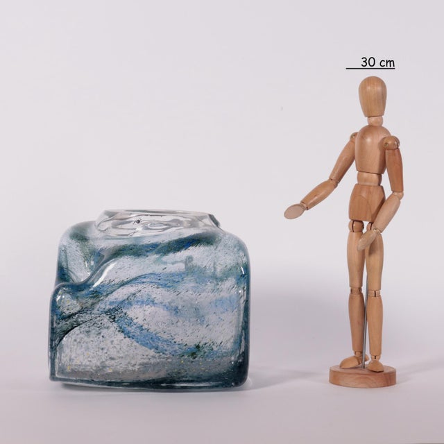 Vase irregular shaped transparent glass with inclusions in shades of blue and green. This piece is attributed to the...