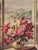 Offset lithograph of a painting of a bowl of red cyclamen in a window with a mountain view. The name of the artist appears...