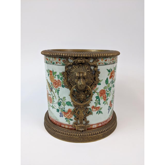 Hand painted planter with decorative flowers and birds. Ormolu mount with lion heads.