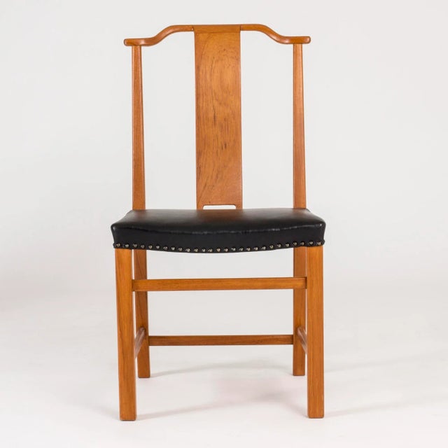 This set of twelve dining chairs in stained wood and leather was designed by Axel Larsson, and custom made for a Swedish...