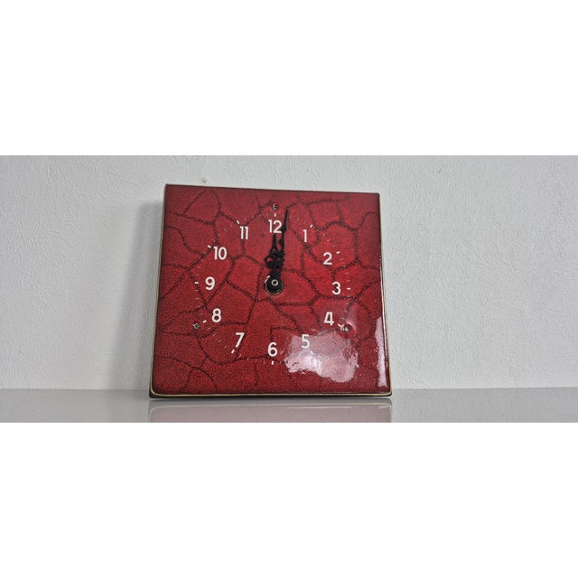 Red ceramic wall clock. Made in Germany in the 1970s