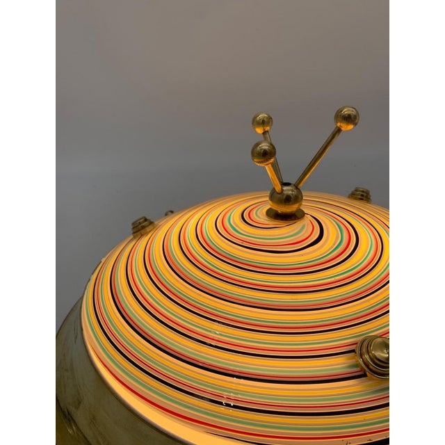 Single lamp attributed to Effetre. Ceiling light with a large circular polished brass frame and a curved glass diffuser...