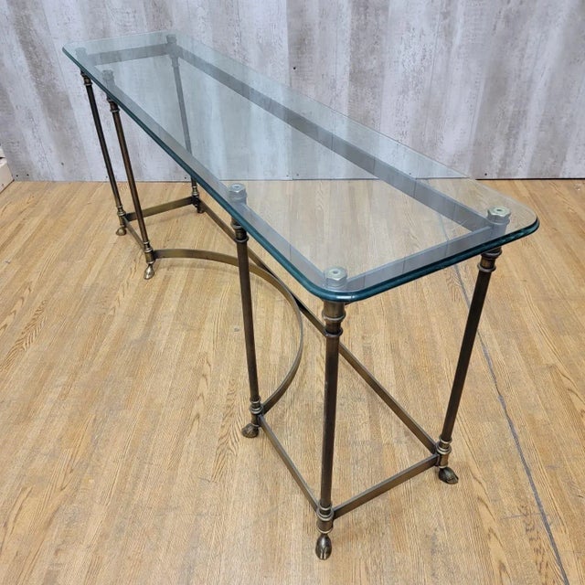 Vintage Hollywood Regency Maison Jansen LaBarge Style Brass Hoofed Feet Glass Top Console Table Featuring Hollywood...