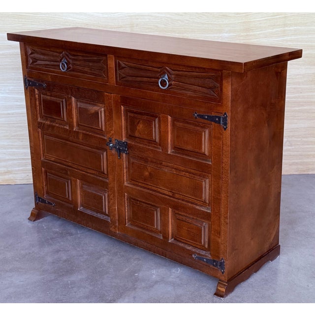 From Northern Spain, constructed of solid walnut, the rectangular top with molded edge atop a conforming case housing two...