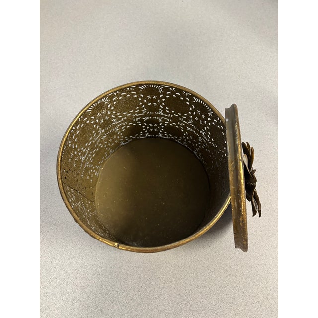 Add a touch of vintage-inspired elegance with this decorative antique gold-tone metal trinket box. Featuring intricate...