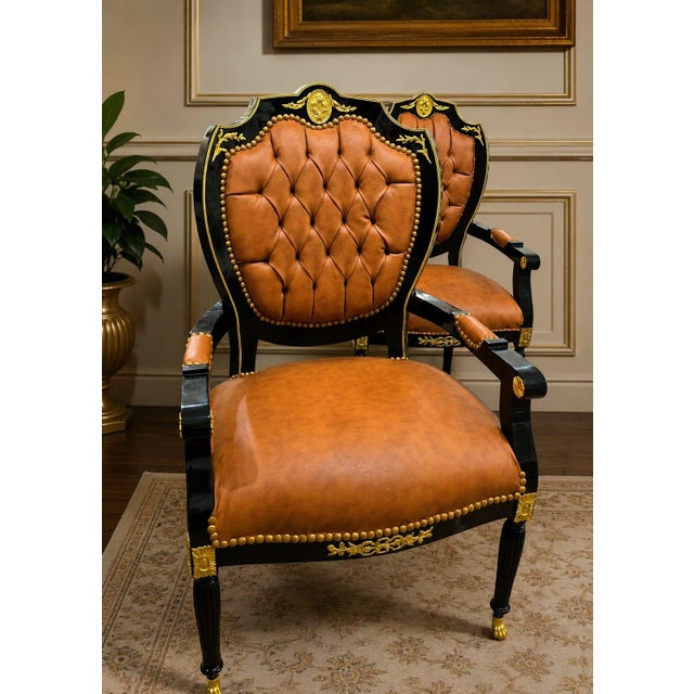 Make a bold statement with this luxurious French Empire style armchair, expertly crafted with rich cognac leather...