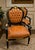 Make a bold statement with this luxurious French Empire style armchair, expertly crafted with rich cognac leather...