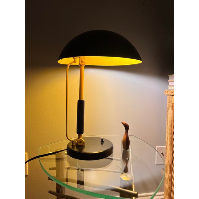 Epic 1930s Karl Trabert designed metal dome desk lamp in black and yellow. The piece is an excellent study in Bauhaus...