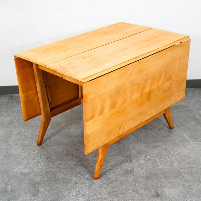 A mid century modern solid birch dining table made by Heywood Wakefield. Professionally refinished in the classic...