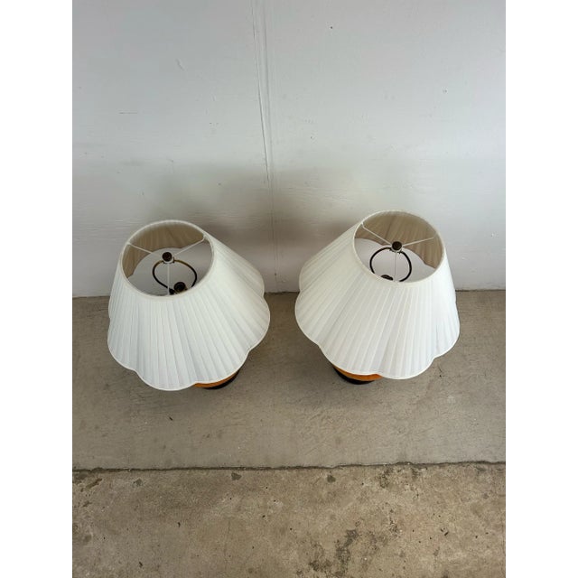 This pair of mid century modern table lamps feature unique shaped ceramic body, beautiful lava glaze with orange, red, and...