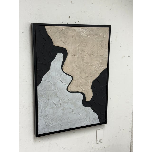 Design Plus Gallery presents a Textural Artwork of Tan with Silver in a Black Frame. The paintings expression is abstract...