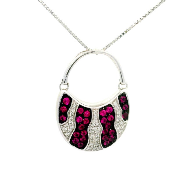 Designed and crafted by the renowned Mikimoto, a captivating pendant necklace featuring a unique design with round-cut...