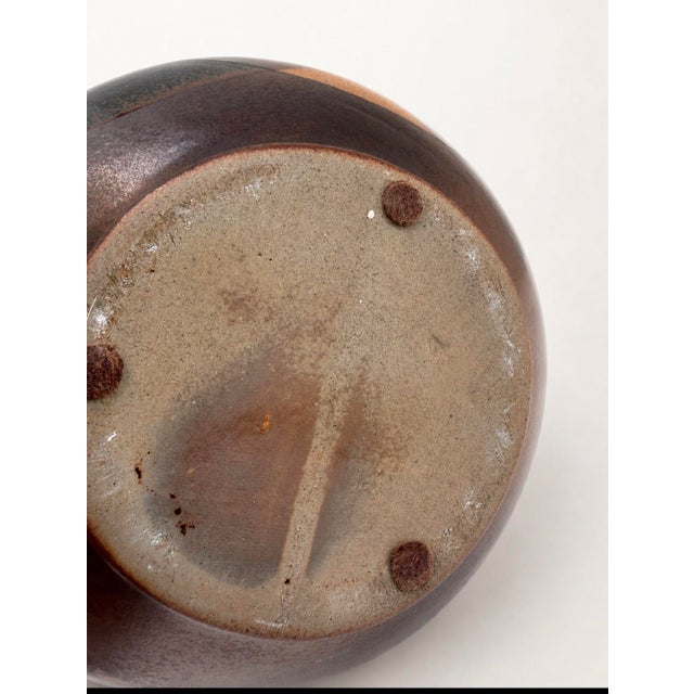 Mid-century studio pottery vase by Robert Maxwell with a rounded form and flared neck. The abstract glaze combines warm...