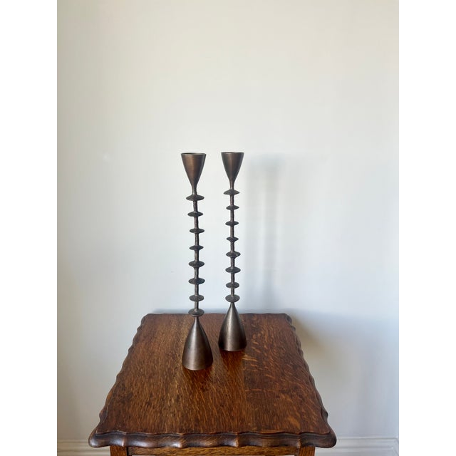 A fabulous pair of large vintage candlesticks, hand crafted in solid brass, circa 1960. The candlesticks have a brutalist...