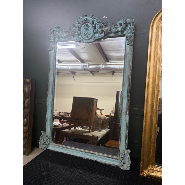 Beautiful Louis XVI style teal polychromed wall mirror. Features a pierced crest with foliated corners and beaded inner...