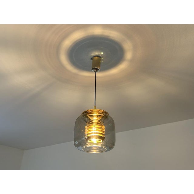 Mid-century gilded pendant light by ecor, model 52 276, design in the manner of jacobsson, featuring a flattened light...