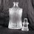 This is a ridged crystal decanter that is an unusual shape-wider at the top and bottom than the middle and narrow from...