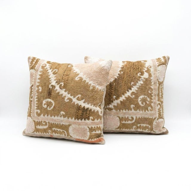This beautiful 22'' x 25'' hand-embroidered Suzani pillow cover set was made from authentic Uzbek cotton fabric. The...