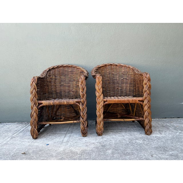 This pair of vintage woven rattan lounge chairs combines a sculptural silhouette with the relaxed, natural warmth that...