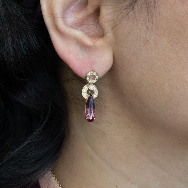 Vibrant 3.7Ct rubellite tourmalines glow with rich pink-red tones, accented by natural diamonds. Set in solid 14K gold,...