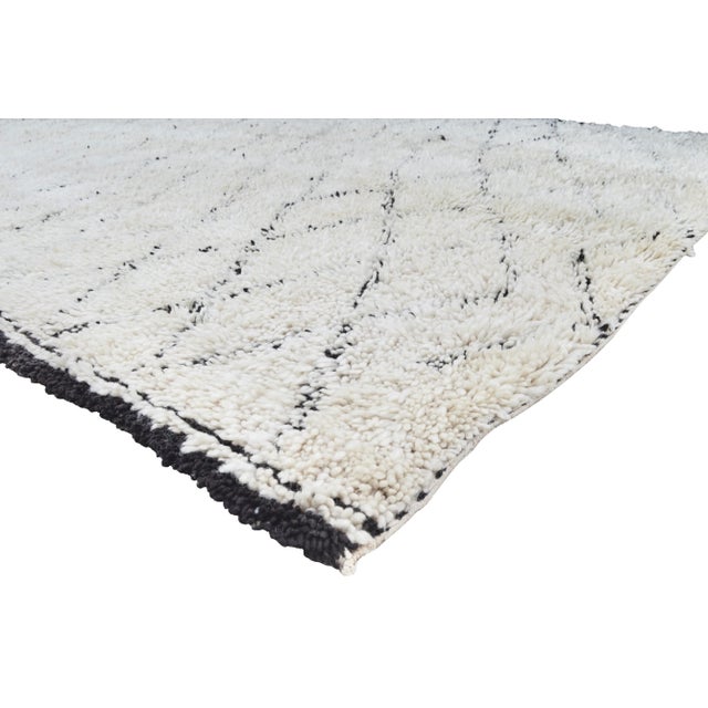 One-of-a-kind hand-knotted Moroccan rug in soft, organic wool with an ornate rhythmic pattern of Berber lozenge motif and...