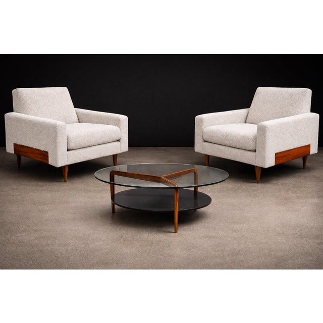 A sculpturally grounded and materially rich pair of Brazilian Modern armchairs, executed in Caviuna wood and newly...