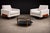 A sculpturally grounded and materially rich pair of Brazilian Modern armchairs, executed in Caviuna wood and newly...