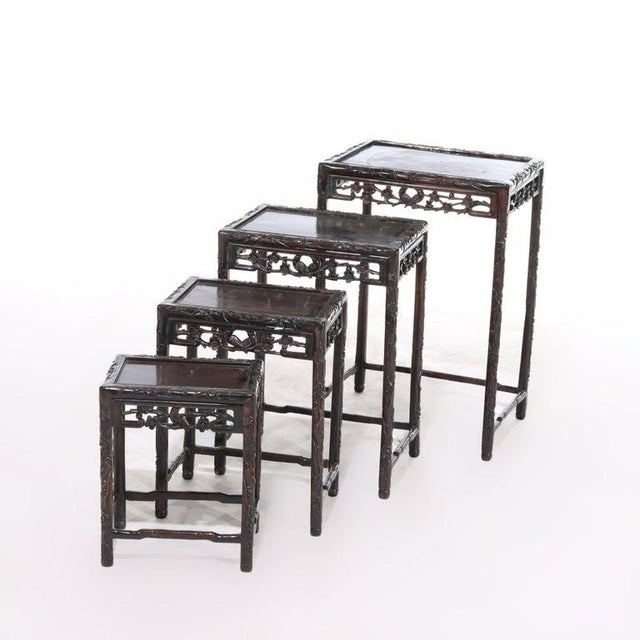Set of Four Antique Chinese Floral & Figural Carved Hardwood Nesting Table C1900 Measures - 16" x 12 3/4" x 8 1/2"; 20" x...