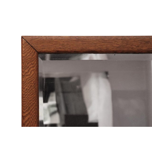 A rectangular beveled glass wall mirror with a simple oak frame. Beautifully grained oak wood is finished with a gently...
