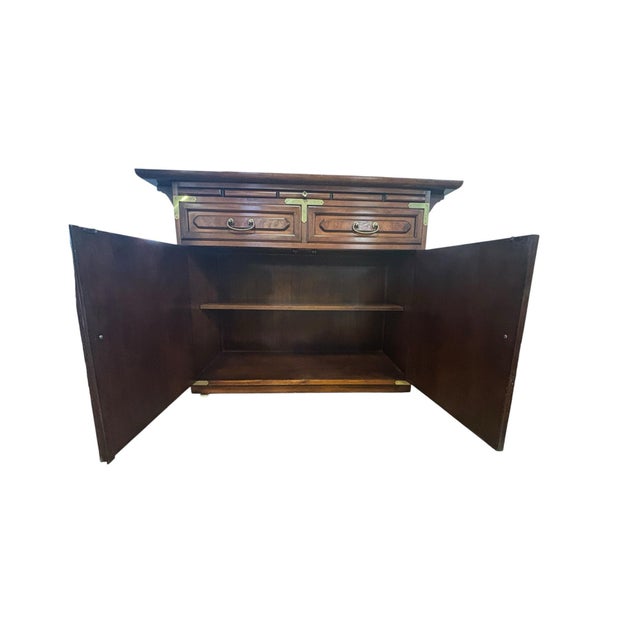 Elegant Asian-inspired server cabinet featuring richly figured wood veneers accented by decorative brass corner mounts,...
