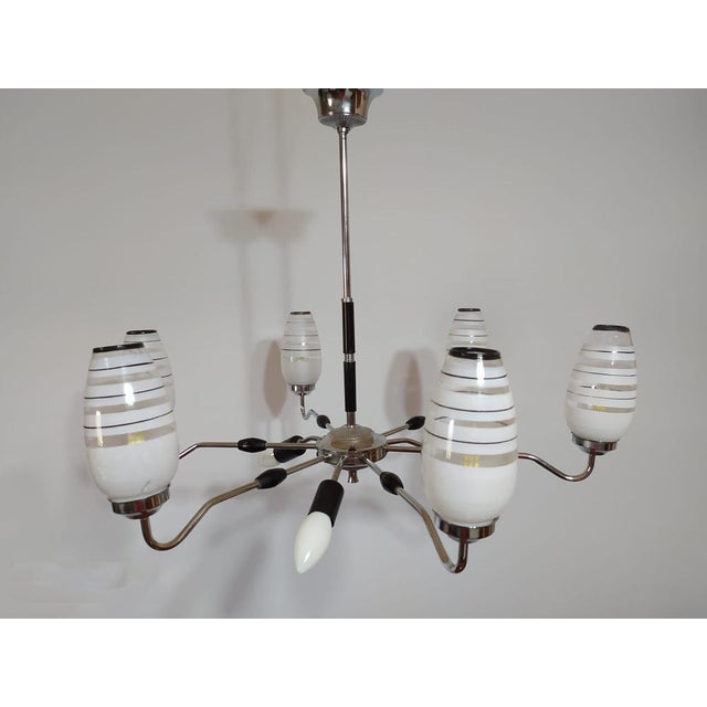 Mid-Centuty chandelier in brass with a chrome plated finish. 6 upper and 3 lower lights. Partially rewired and in perfect...