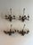 A set of antique iron sconces from 1900, gilded and adorned with botanical floral details, offering timeless elegance and...