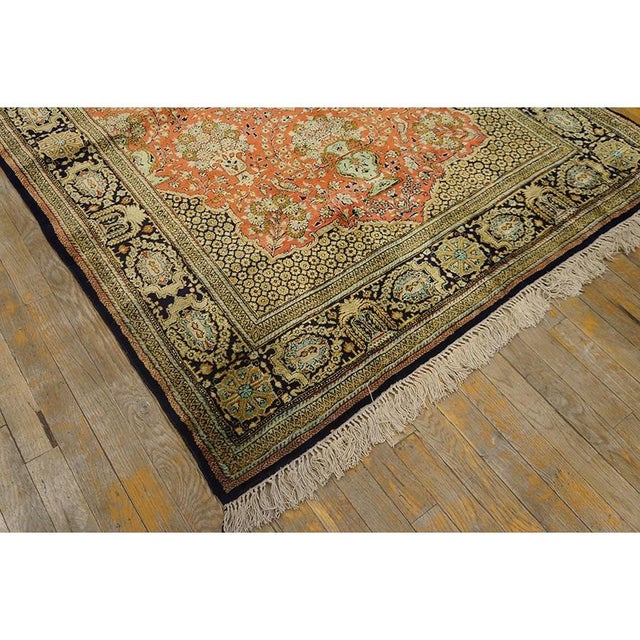 A one-of-a-kind vintage Qum silk rug, The composition centers on a medallion design over a beige ground, executed in the...
