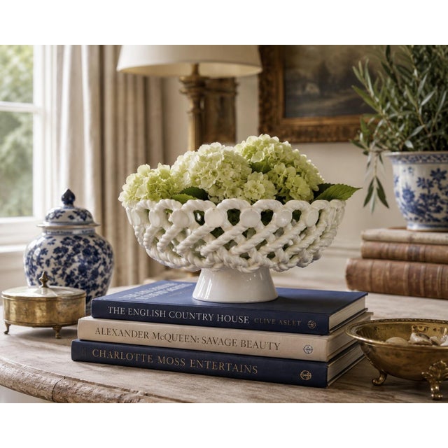 An elegant trompe l'oeil porcelain cachepot or fruit bowl crafted in the form of a handwoven rope basket. Executed in...