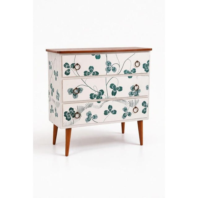 A distinctive 1950s Scandinavian Modern three-drawer commode, professionally wallpapered with Josef Frank’s iconic clover...