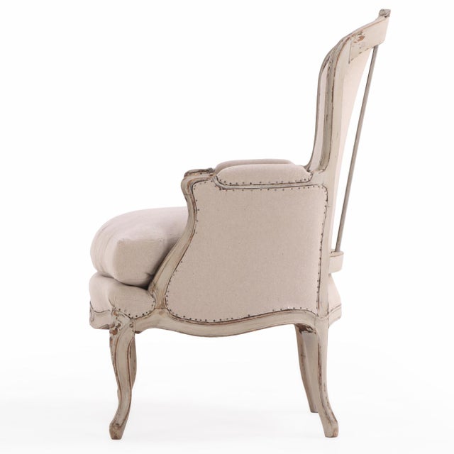 Beautifully detailed, this classic bergère features a carved and painted frame with scrolling arms and cabriole legs. A...