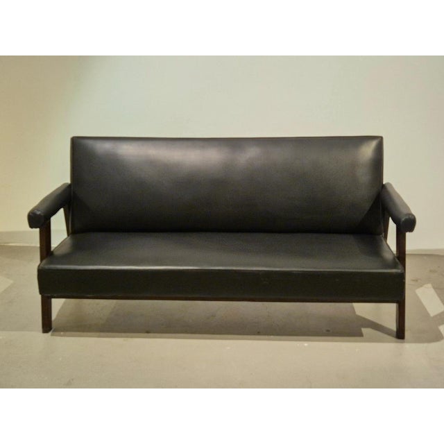 Pierre Jeanneret, SI-41-B sofa in teak and reupholstered in black leather. Jeanneret was commissioned by the city of...