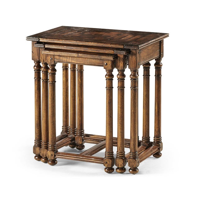 This exquisite set of three nesting tables is a testament to fine craftsmanship, featuring inlaid parquet oyster tops with...