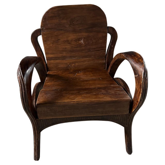 Unusual hand carved arms on this teak arm chair from Sumatra with a high polish. Circa 1950. Full dimensions; Arm to arm...