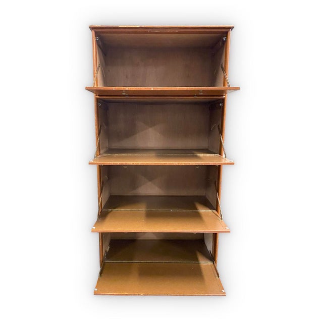 This cabinet is fully wrapped in leather and has gold embossed detailing. Brass and rubber casters allow for easy moving....