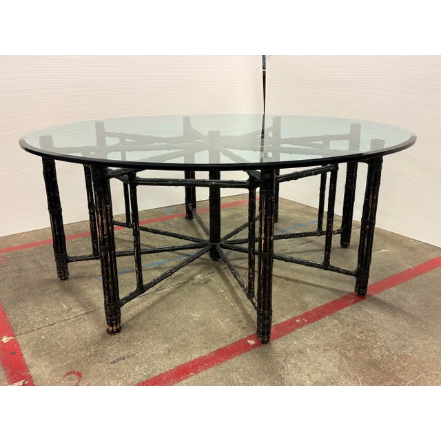 Design Plus Gallery presents a Dining Table from McGuire Furniture. A round beveled glass top rests on a metal frame...