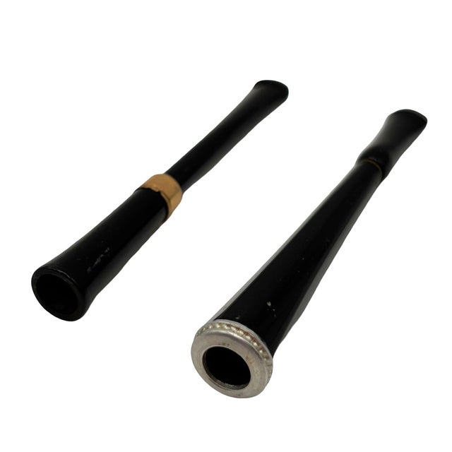 A striking pair of 1930s Art Deco cigarette holders crafted from rich, genuine Bakelite. Featuring elegant, tapered...