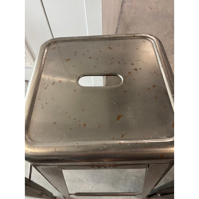 Set of four counter height Tolix Marais steel bar stools. Designed by Xavier Pauchard for Design Within Reach. Stackable.