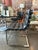 Restoration Hardware black leather Oviedo Dining Chairs featuring a stainless steel frame and channel tufted cushions....